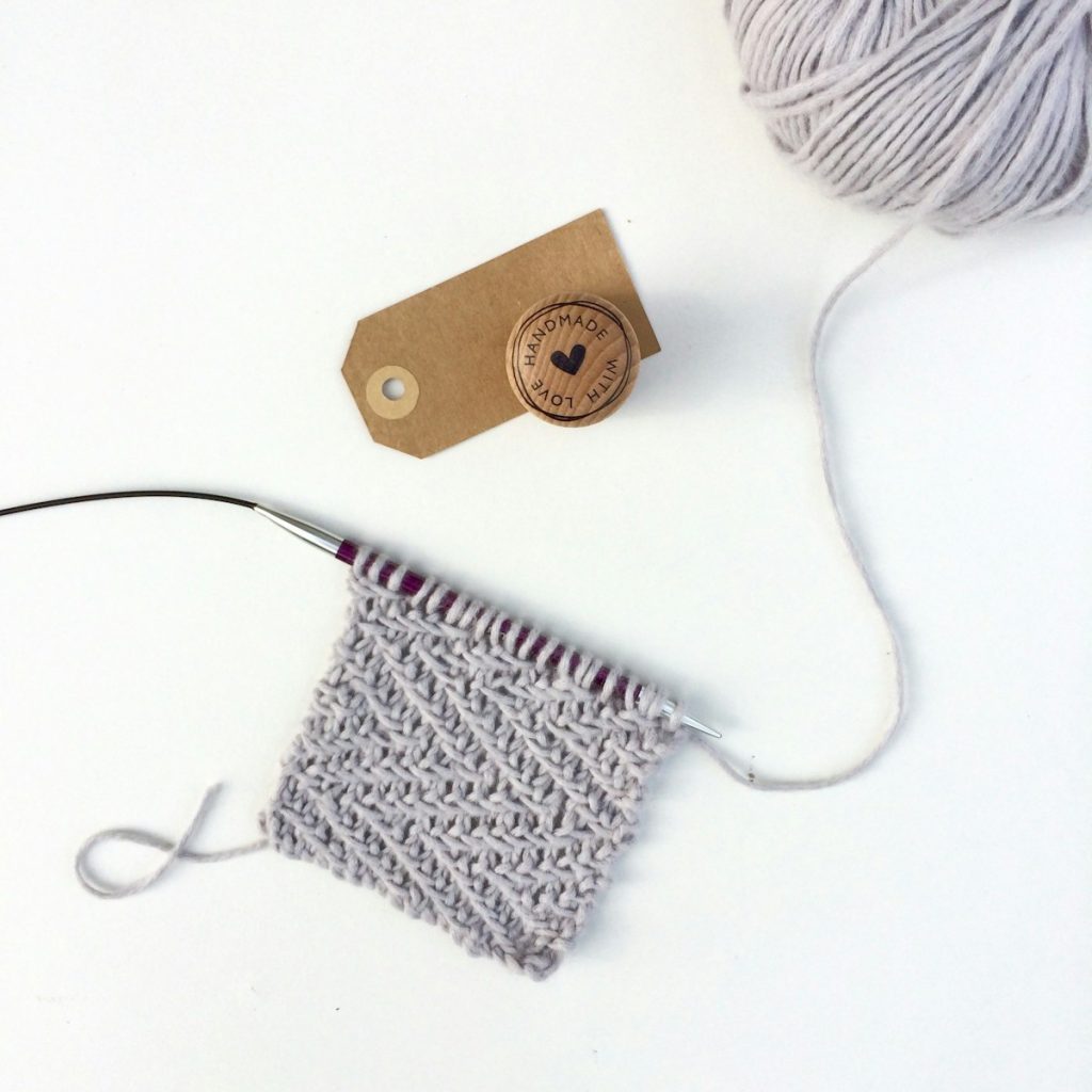 white earbuds on white textile